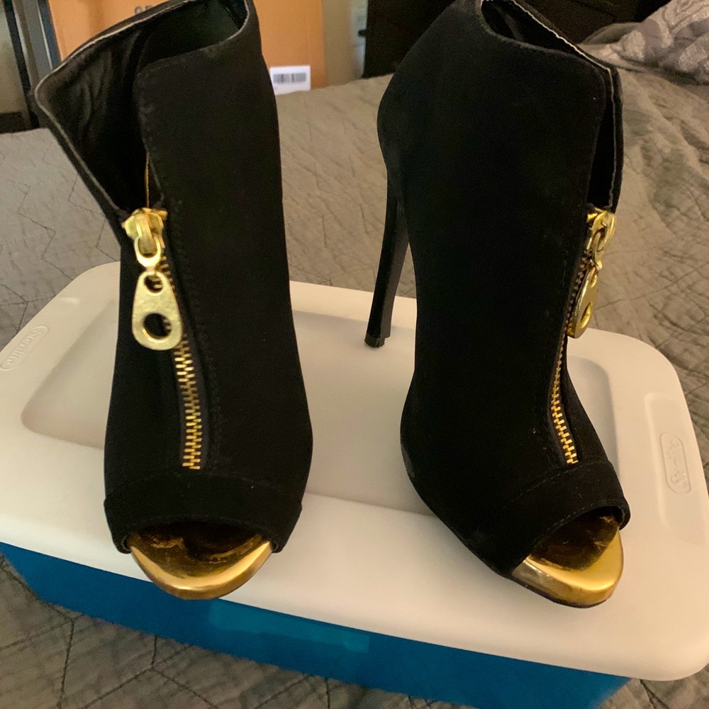 Black booties with gold accents